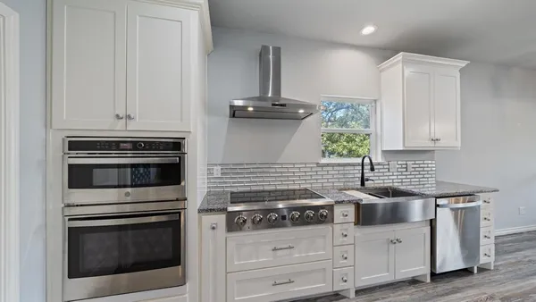 a view of a kitchen with a sink and a microwave