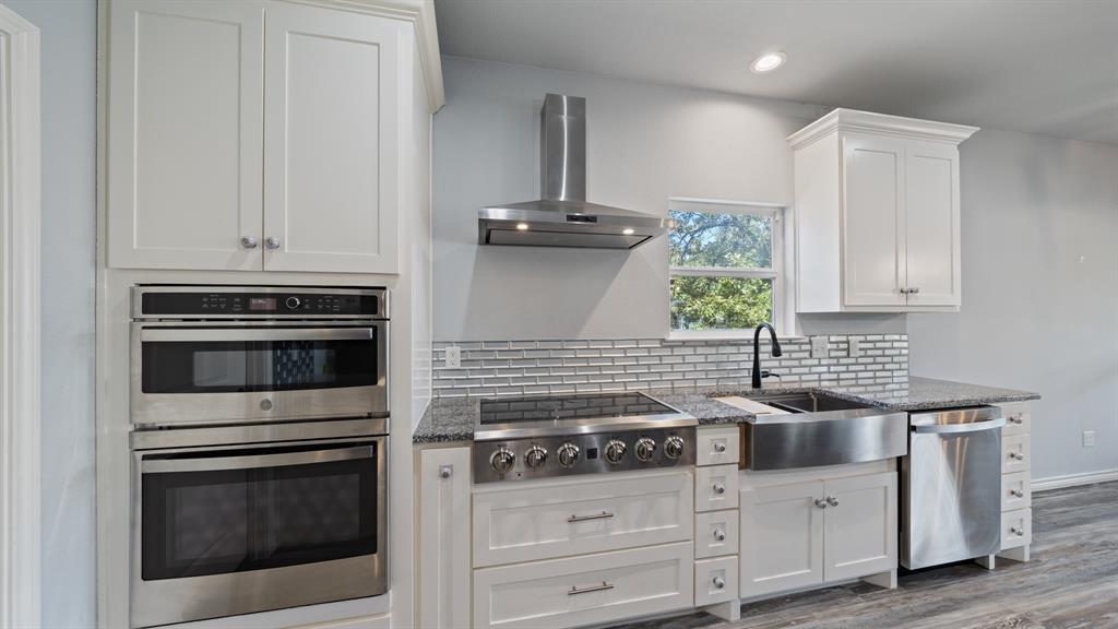151 Sun Down Trail Mabank, TX 75156 - Photo 19 of 29 a kitchen with granite countertop white cabinets and appliances