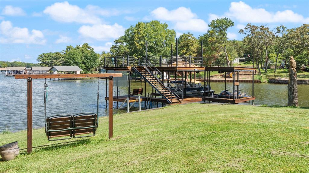 151 Sun Down Trail Mabank, TX 75156 - Photo 23 of 29 a view of a swimming pool with a bench and trees in the background