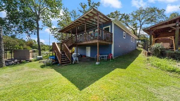 a view of a house with a yard and sitting area