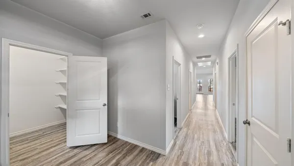 a view of a hallway with wooden floor