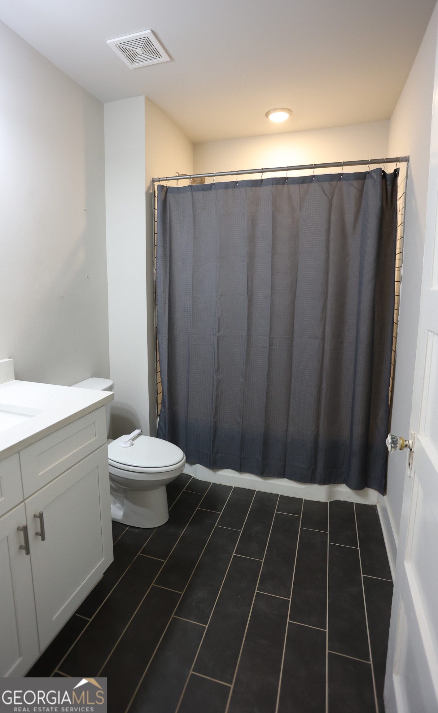 68 Hayes Street Toccoa, GA 30577 - Photo 13 of 33 a bathroom with a toilet a sink and shower