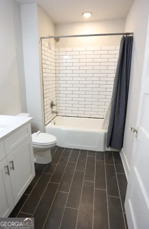 a bathroom with a toilet a sink and a shower