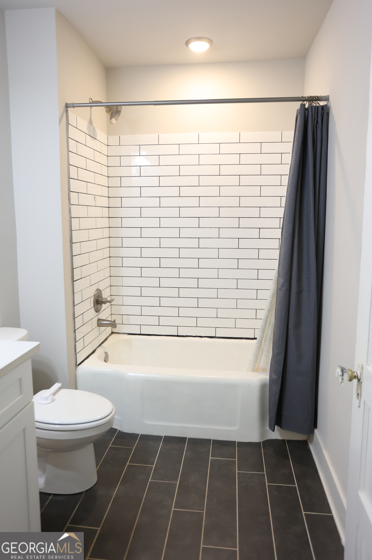 68 Hayes Street Toccoa, GA 30577 - Photo 16 of 33 a bathroom with a toilet and a bathtub