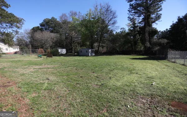 a view of a field of grass and trees