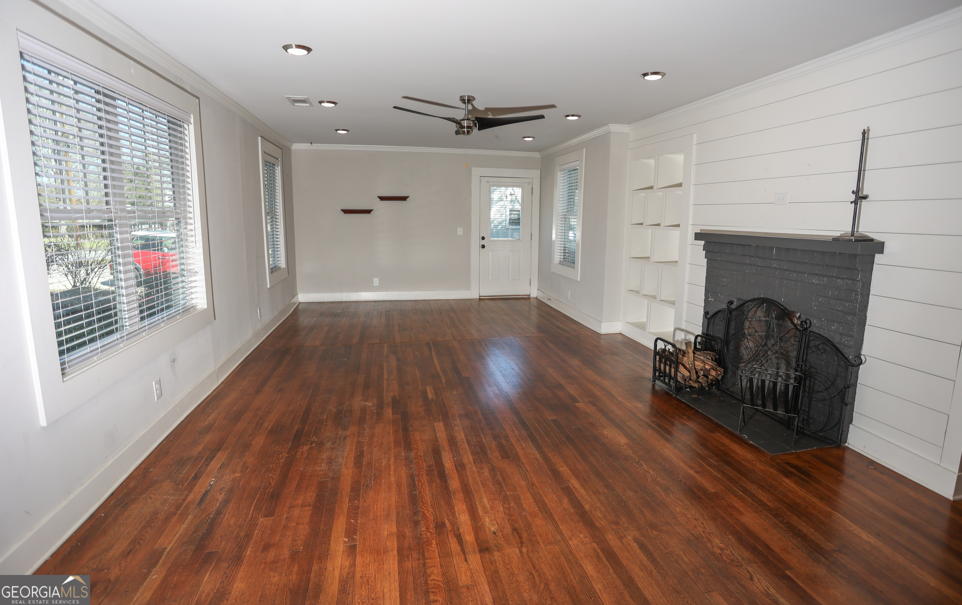 68 Hayes Street Toccoa, GA 30577 - Photo 3 of 33 a view of empty room with wooden floor and fireplace