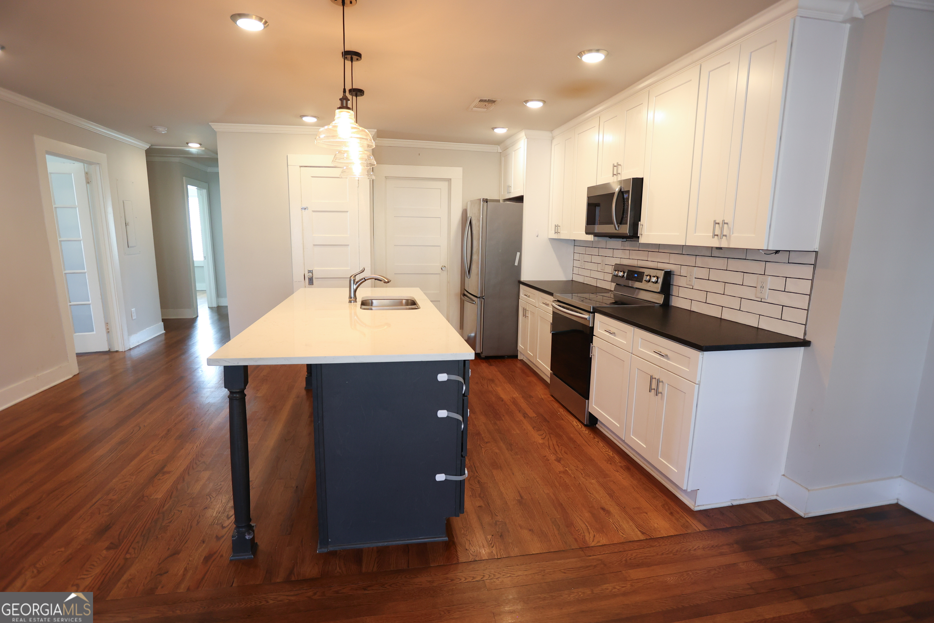 68 Hayes Street Toccoa, GA 30577 - Photo 32 of 33 a kitchen with stainless steel appliances granite countertop a sink stove and refrigerator