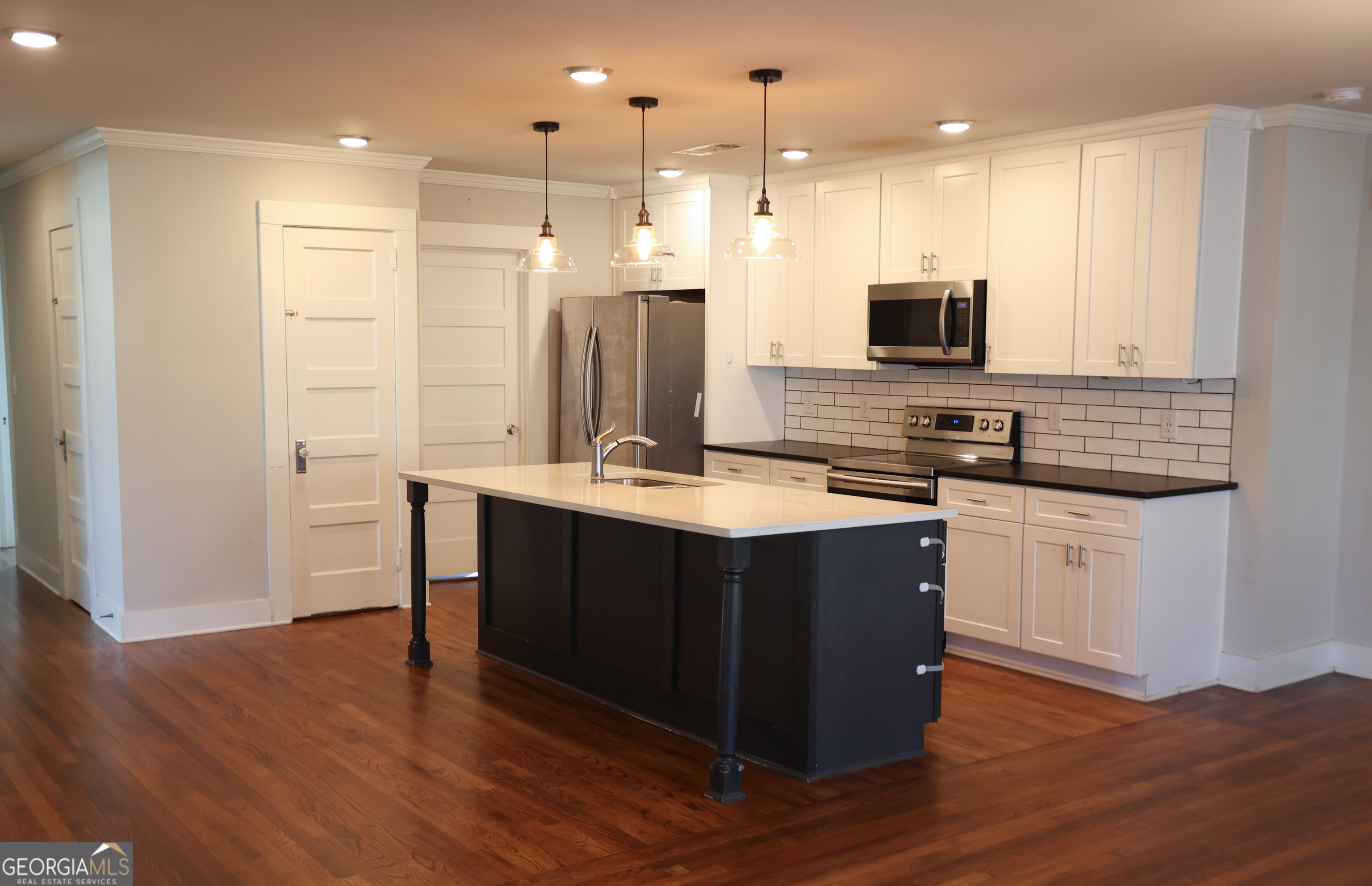 68 Hayes Street Toccoa, GA 30577 - Photo 33 of 33 a kitchen with stainless steel appliances kitchen island granite countertop a stove a sink and a refrigerator
