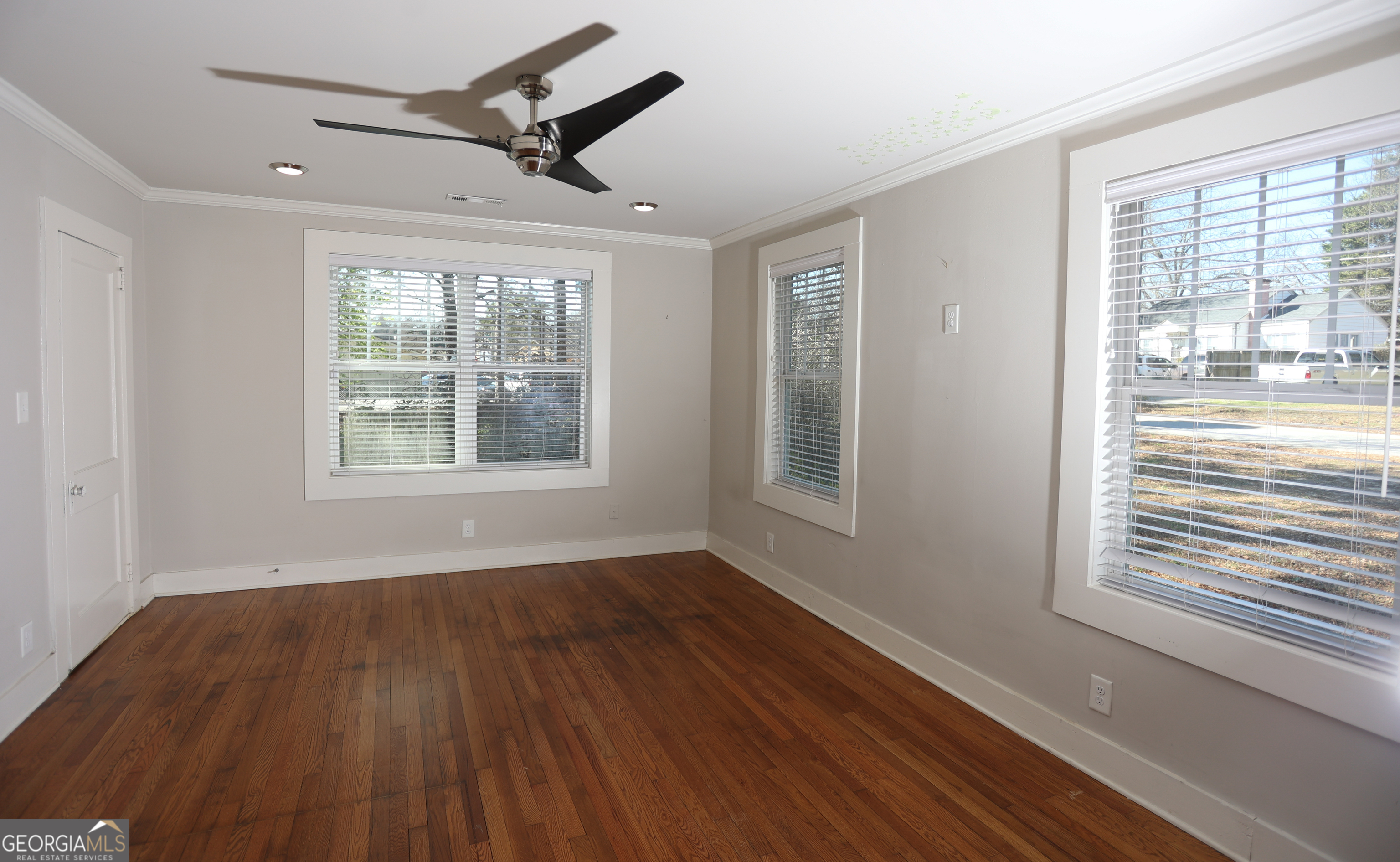 68 Hayes Street Toccoa, GA 30577 - Photo 5 of 33 a view of an empty room with wooden floor and a window