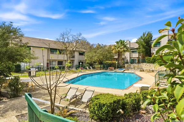 a view of a swimming pool with a patio