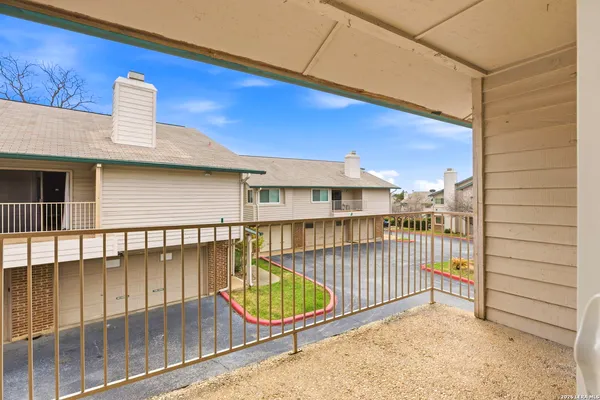 a view of a balcony with a barbeque