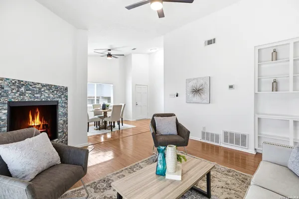 a living room with furniture fireplace and wooden floor
