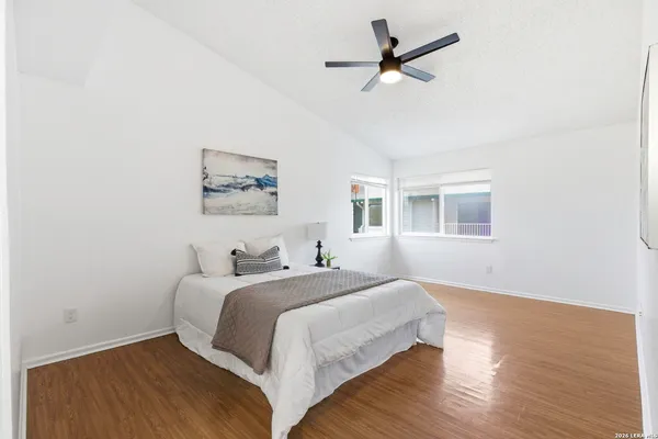 a bedroom with a large bed chandelier and a window