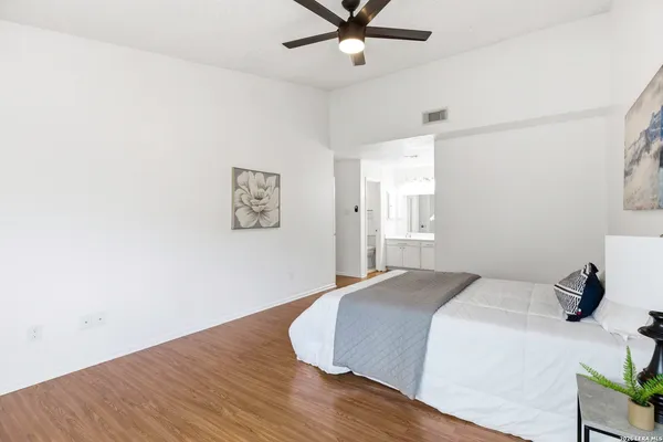 a bedroom with a bed and wooden floor
