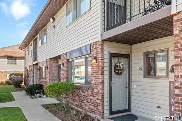 a view of a brick house with many windows