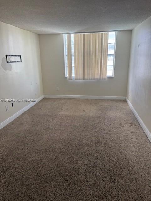 492 Northwest 165th Street, Unit C510 Miami, FL 33169 - Photo 4 of 9 an empty room with windows