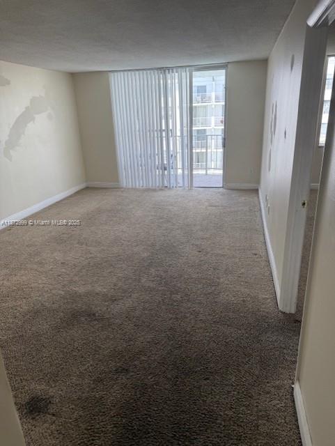 492 Northwest 165th Street, Unit C510 Miami, FL 33169 - Photo 5 of 9 an empty room with windows