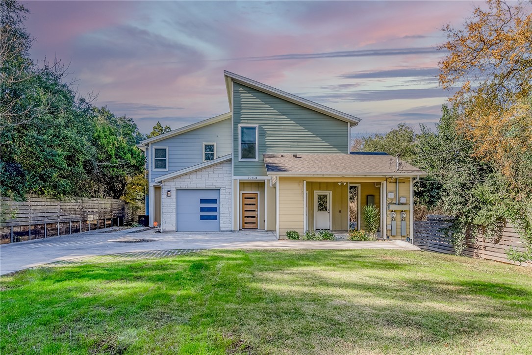a front view of house with yard and outdoor seating