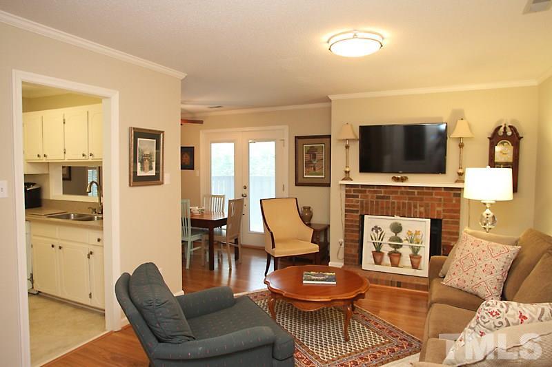 3405 Mill Run Raleigh, NC 27612 - Photo 2 of 12 a living room with furniture a flat screen tv and kitchen view