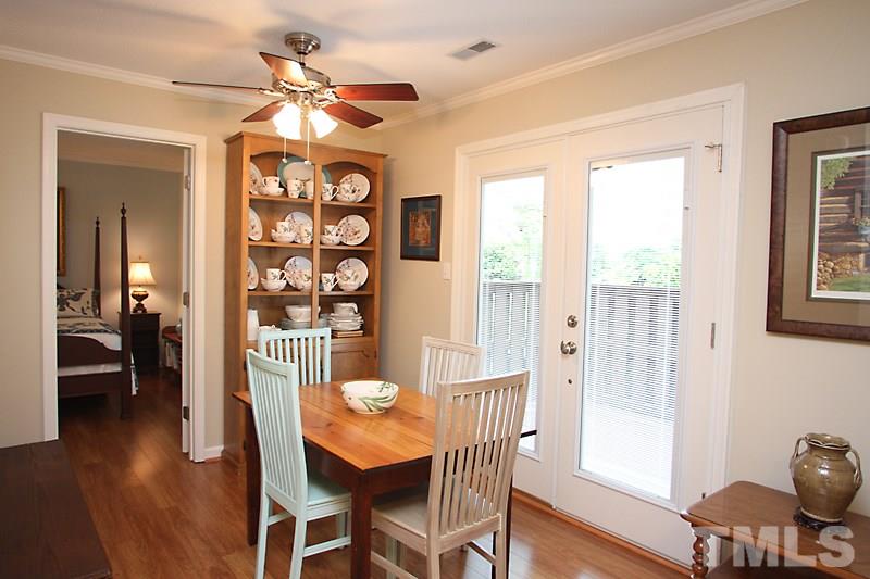 3405 Mill Run Raleigh, NC 27612 - Photo 4 of 12 a view of a dining room with furniture window and wooden floor