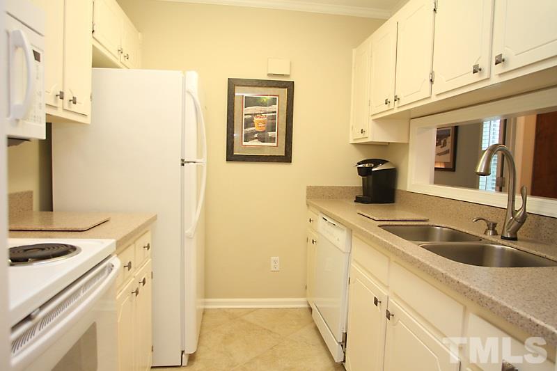 3405 Mill Run Raleigh, NC 27612 - Photo 5 of 12 a kitchen with stainless steel appliances granite countertop a sink and a refrigerator
