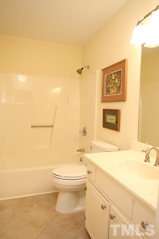 3405 Mill Run Raleigh, NC 27612 - Photo 7 of 12 a bathroom with a toilet sink and mirror