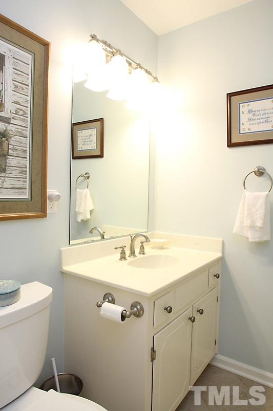 3405 Mill Run Raleigh, NC 27612 - Photo 9 of 12 a bathroom with a sink mirror vanity and toilet