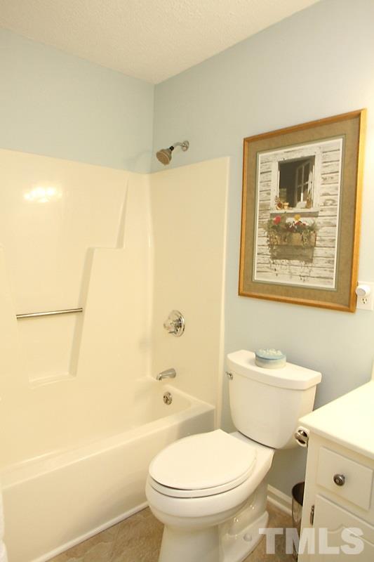 3405 Mill Run Raleigh, NC 27612 - Photo 10 of 12 a white toilet sitting next to a bathroom sink and a shower
