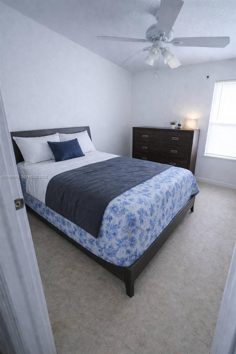 2145 Northwest 68th Terrace Miami, FL 33147 - Photo 5 of 12 a bedroom with a bed and window