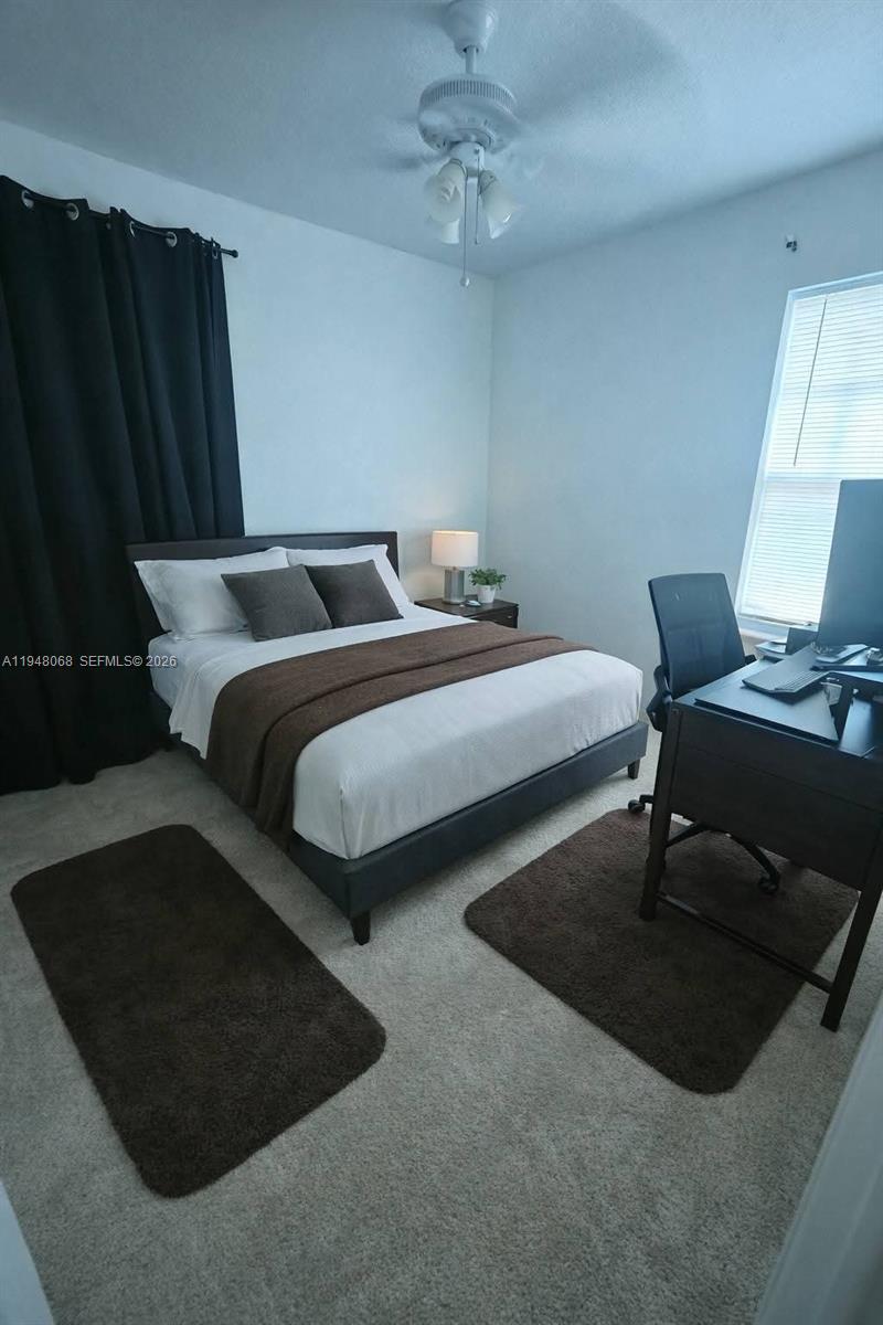 2145 Northwest 68th Terrace Miami, FL 33147 - Photo 6 of 12 a bedroom with bed and window