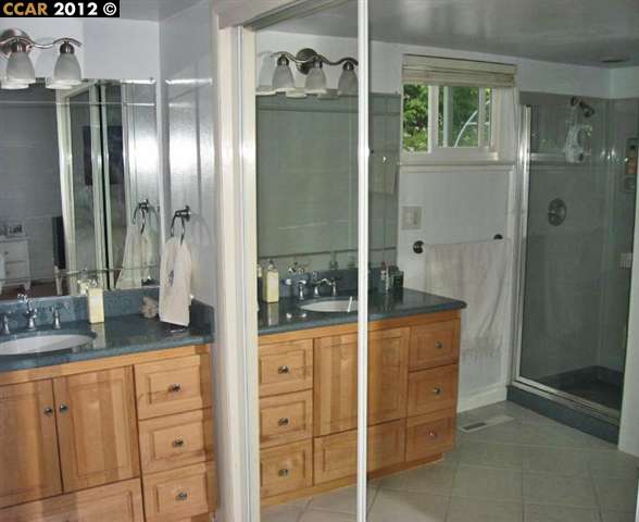 55 Gate Road Walnut Creek, CA 94598 - Photo 14 of 22 a bathroom with a granite countertop sink a mirror and a shower