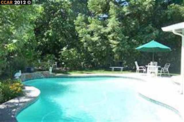 55 Gate Road Walnut Creek, CA 94598 - Photo 16 of 22 a view of a swimming pool with an outdoor seating and a yard