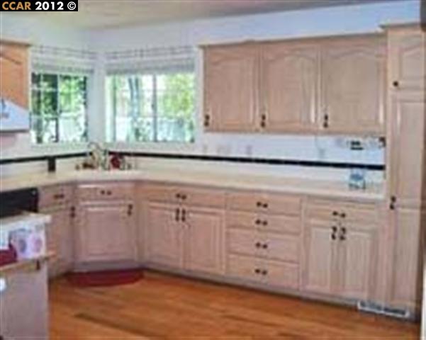 55 Gate Road Walnut Creek, CA 94598 - Photo 4 of 22 a kitchen with cabinets appliances and a window