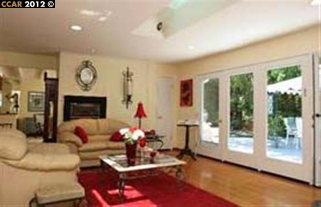 55 Gate Road Walnut Creek, CA 94598 - Photo 6 of 22 a living room with furniture fireplace and a large window