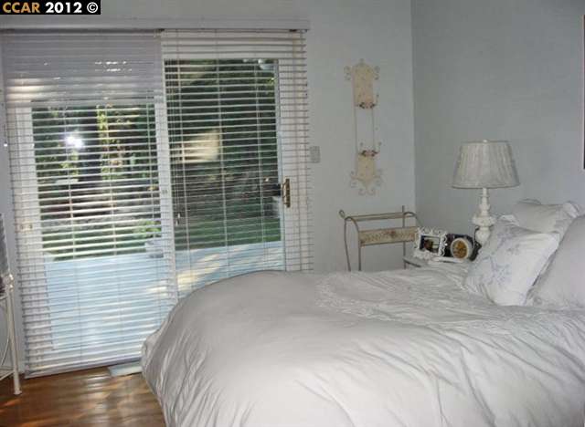 55 Gate Road Walnut Creek, CA 94598 - Photo 9 of 22 a bedroom with a bed and a window