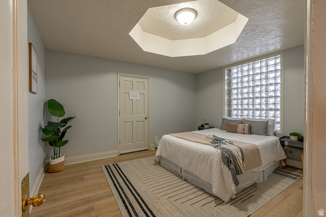 33 North 200 East Logan, UT 84321 - Photo 22 of 54 Bedroom with a textured ceiling and light wood-style floors