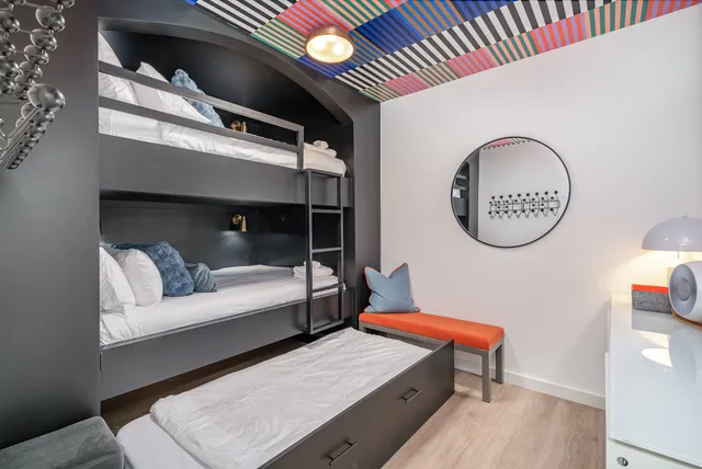 a living room with furniture and a mirror