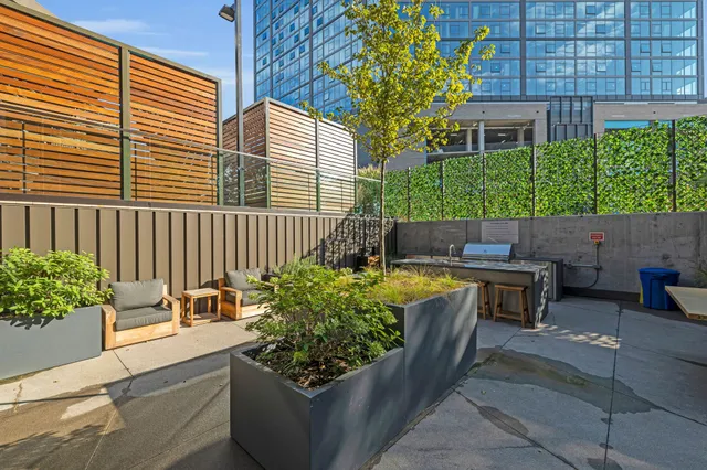 a view of a patio with a table and chairs and potted plants