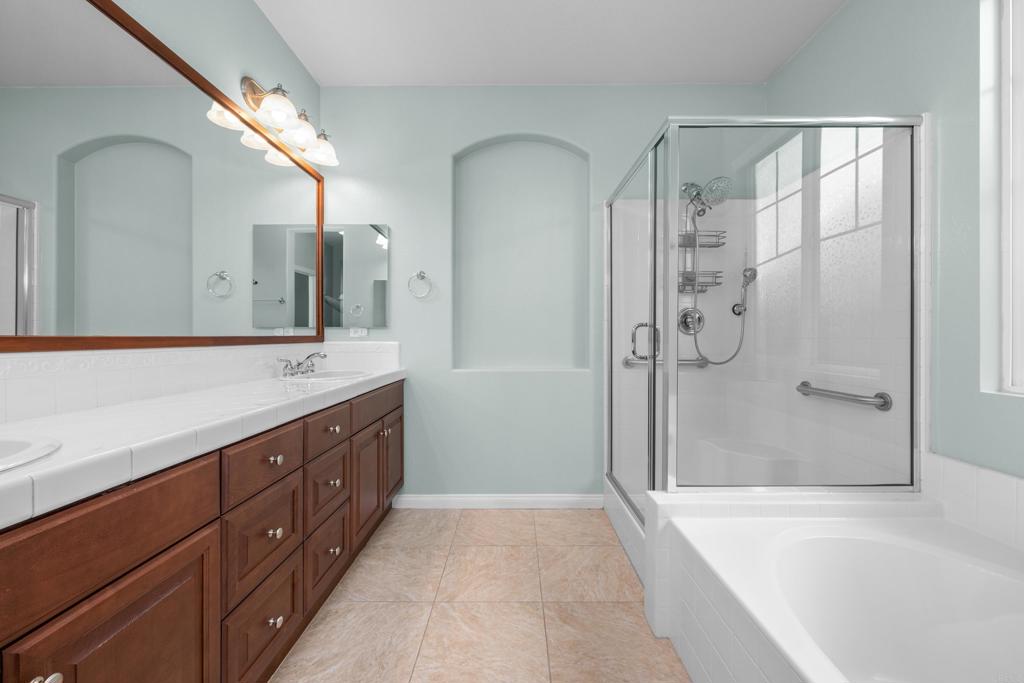 40296 Pasadena Drive Temecula, CA 92591 - Photo 17 of 36 a bathroom with a double vanity sink mirror double and shower