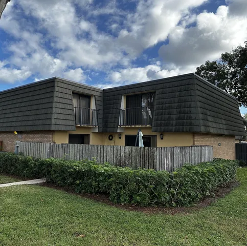 a view of a house with a yard and plants
