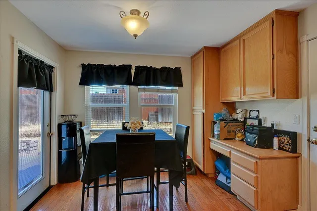 a kitchen with a table chairs and refrigerator