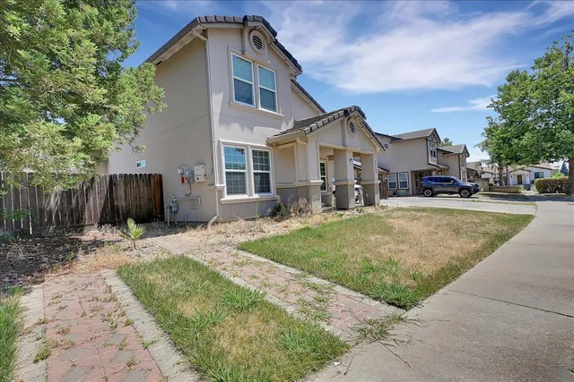 a front view of a house with a yard