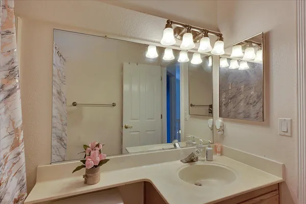 a bathroom with a sink and a mirror