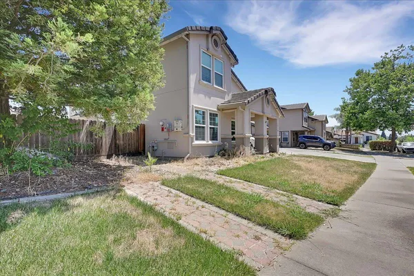 a front view of a house with a yard