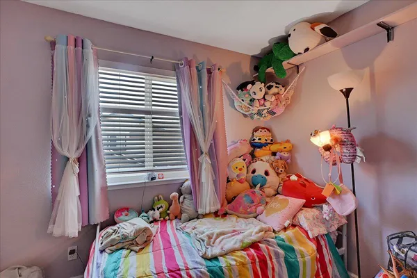 a bed sitting in a bedroom next to a window