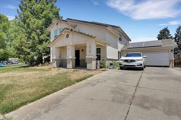 a car parked in front of white house