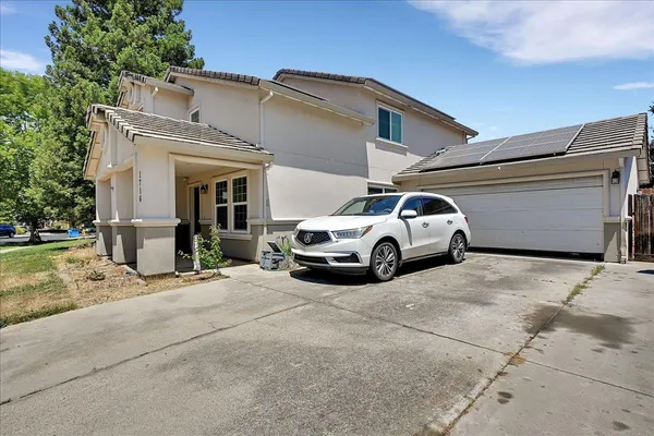a view of a car park in front of house