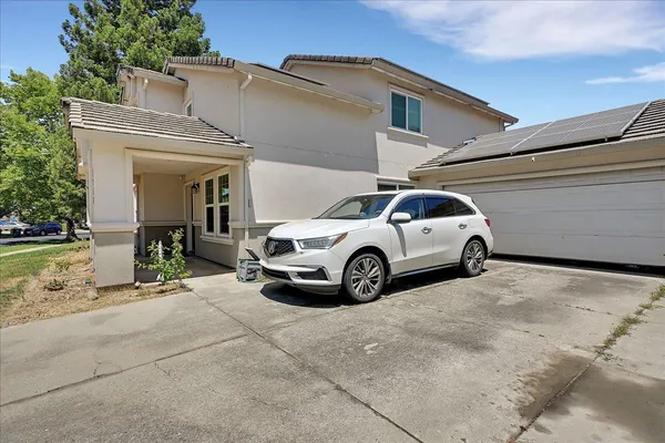 a view of a car parked in front of a house