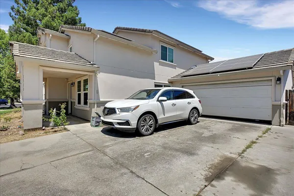 a view of garage with a car parked in it