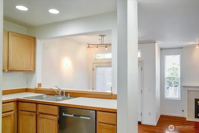 a view of a hallway with wooden floor and closet